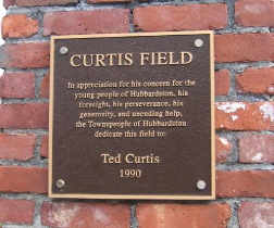 Metal plaque titled Curtis Field - with text below in appreciation of Ted Curtis