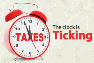 red clock with taxes written on the clock face with writing stating  the clock is ticking