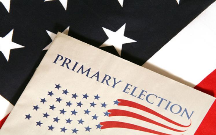 primary election written on a piece of paper with a flag background
