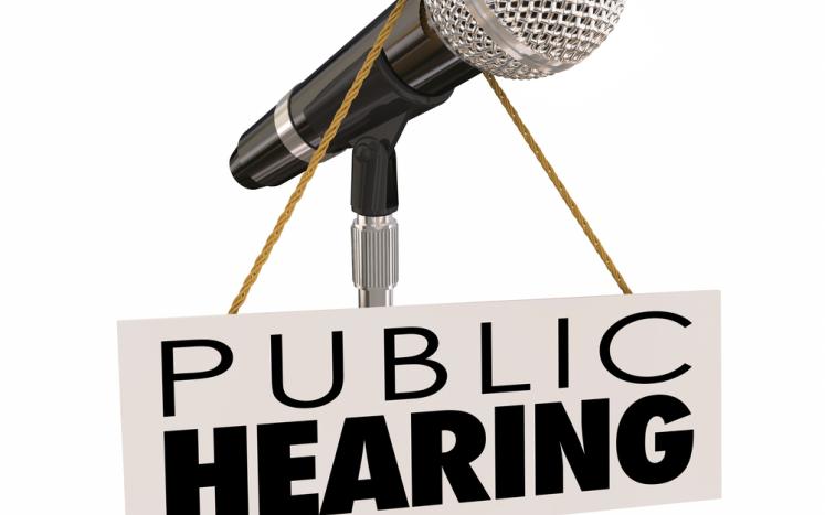 Microphone with a Public Hearing Sign Attached