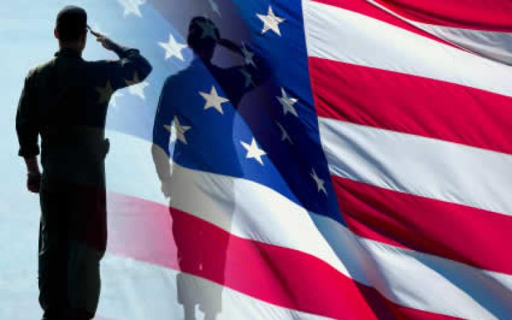 military silhouette saluting the American Flag
